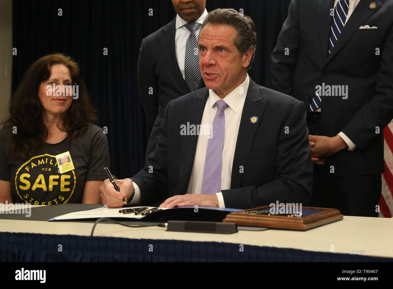 May 12, 2019 - New York, NY, USA - May 12, 2019 -  Governor Andrew M. Cuomo signed legislation at a press conference to set up speed cameras in front of New York schools at  the New York State Offices on 633 3rd Avenue.Founder of Families For Safe Streets  Amy Cohen, Counsel to the Governor Alphonso David, and Governor Andrew Cuomo as he signs the bill. (Credit Image: © Dan Herrick/ZUMA Wire) Stock Photo