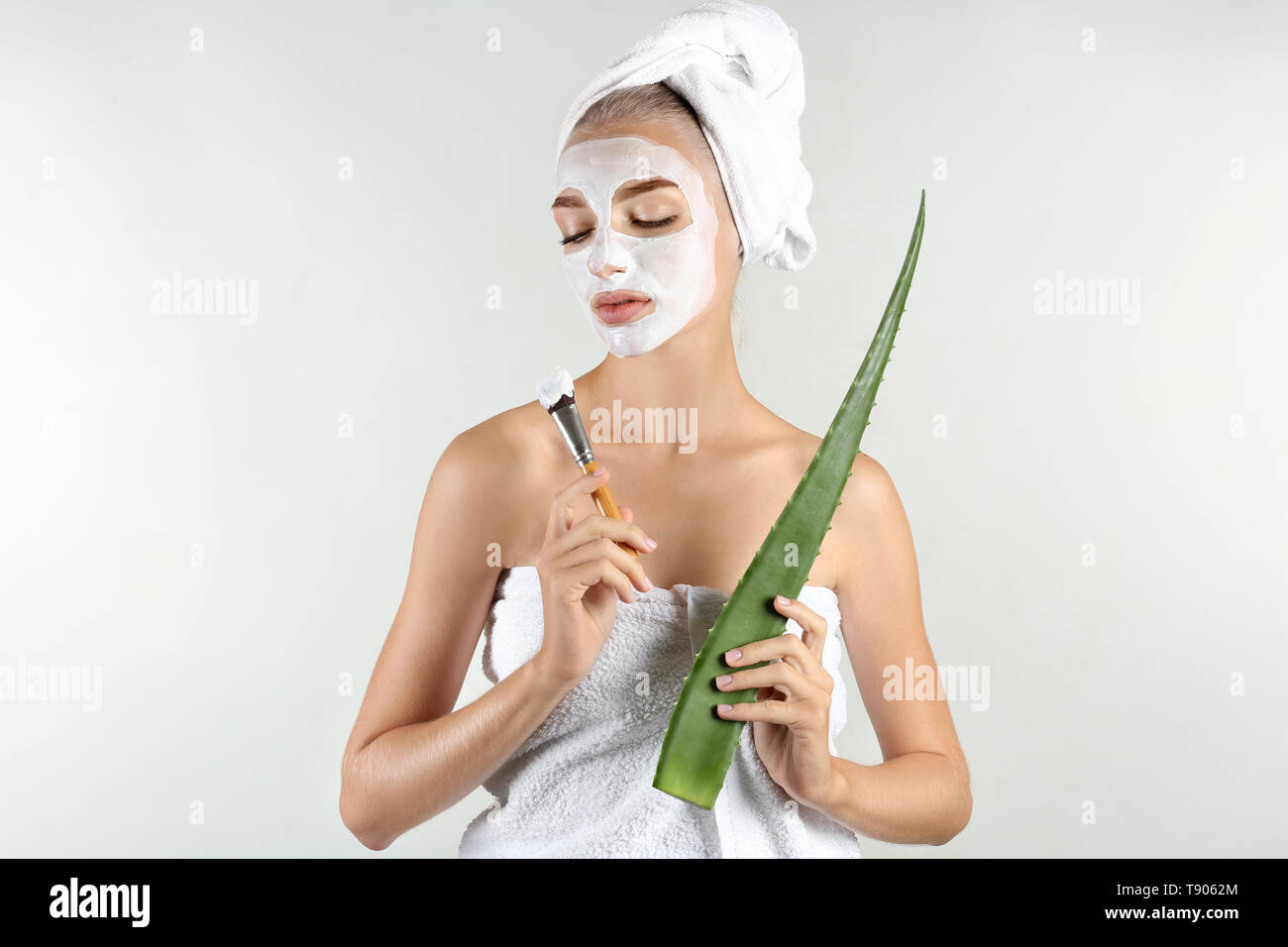 Download Beautiful Young Woman With Facial Mask Containing Aloe Vera Extract On Light Background Stock Photo Alamy PSD Mockup Templates