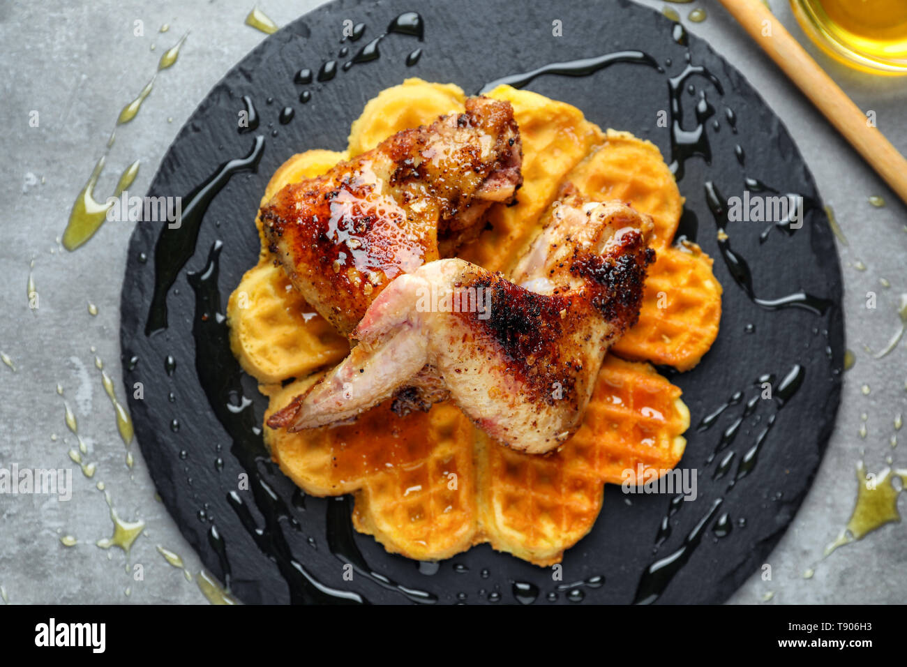 Delicious Waffles With Chicken Wings On Slate Plate Stock Photo Alamy