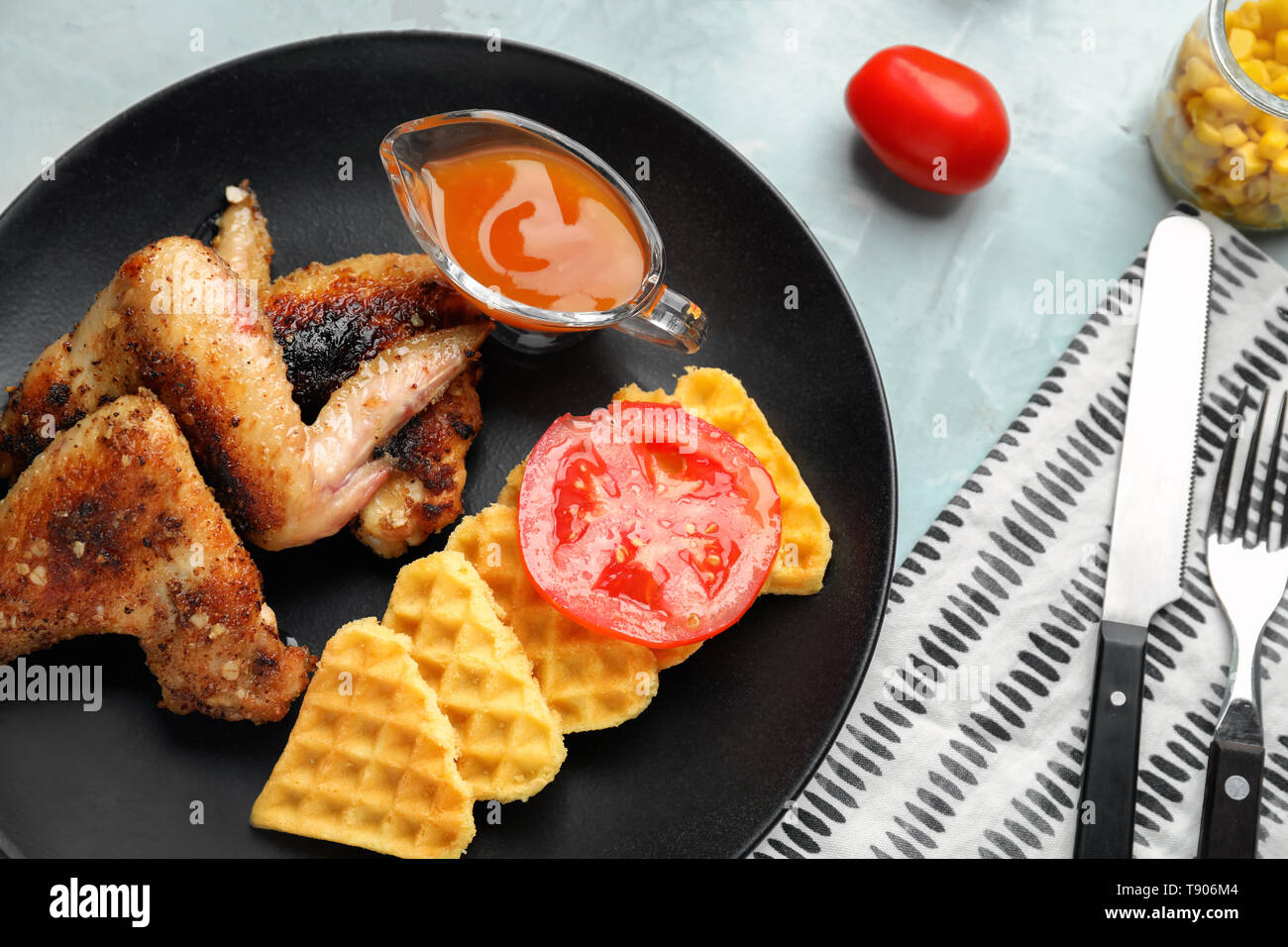 Delicious waffles with chicken wings and sauce on plate Stock Photo Alamy