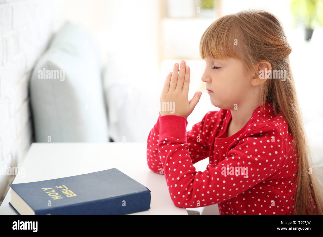 Little girl praying at home Stock Photo Alamy