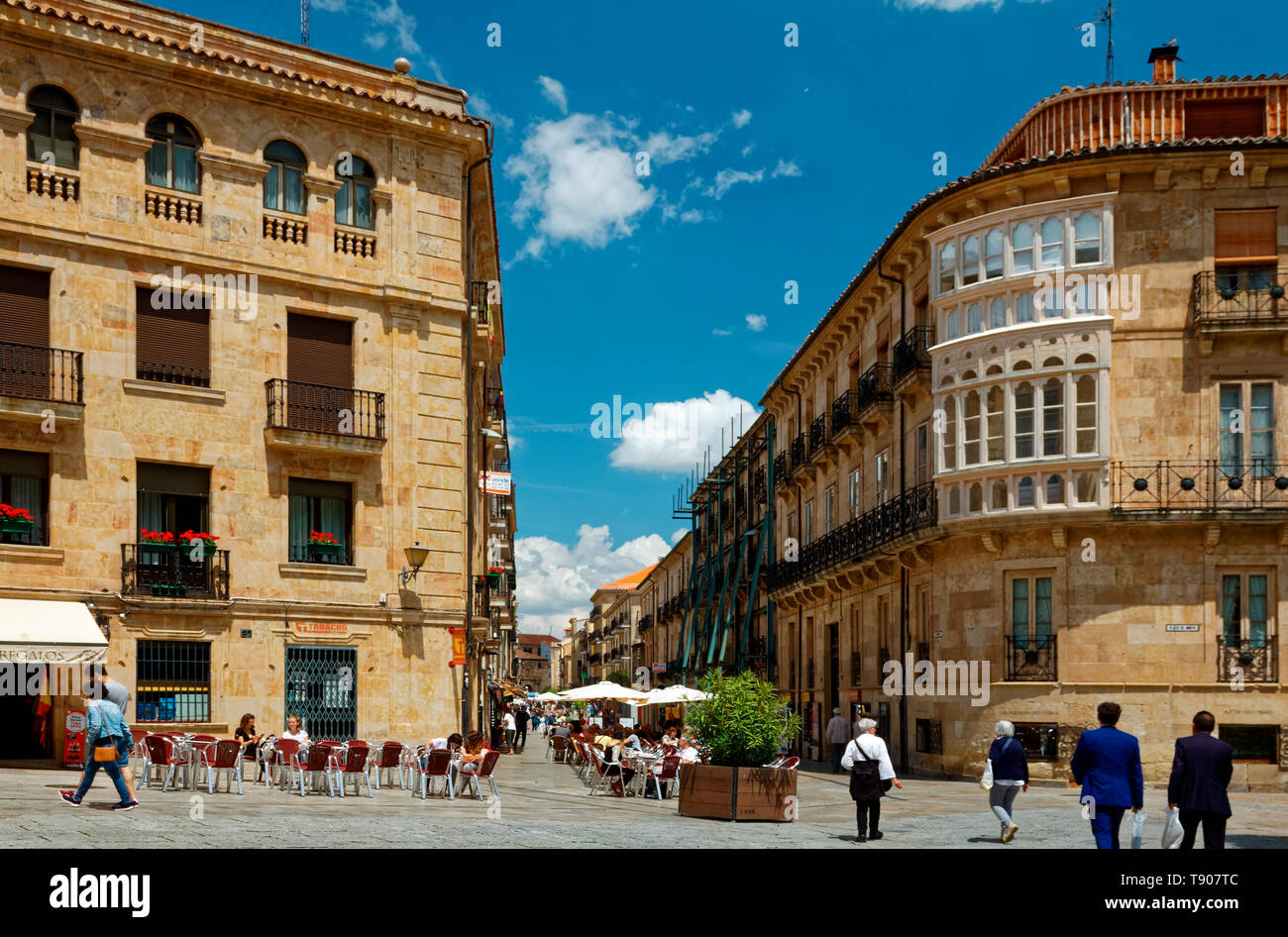 city scene; old sandstone buildings, pedestrian street, tables, chairs, umbrellas, people, UNESCO site; Europe; Salamanca; Spain; spring, horizontal Stock Photo