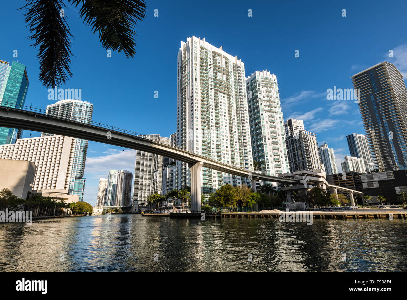 Miami, FL, USA - April 19, 2019: View of downtown financial and residential buildings and Brickell key on a spring day with blue sky and green waters Stock Photo