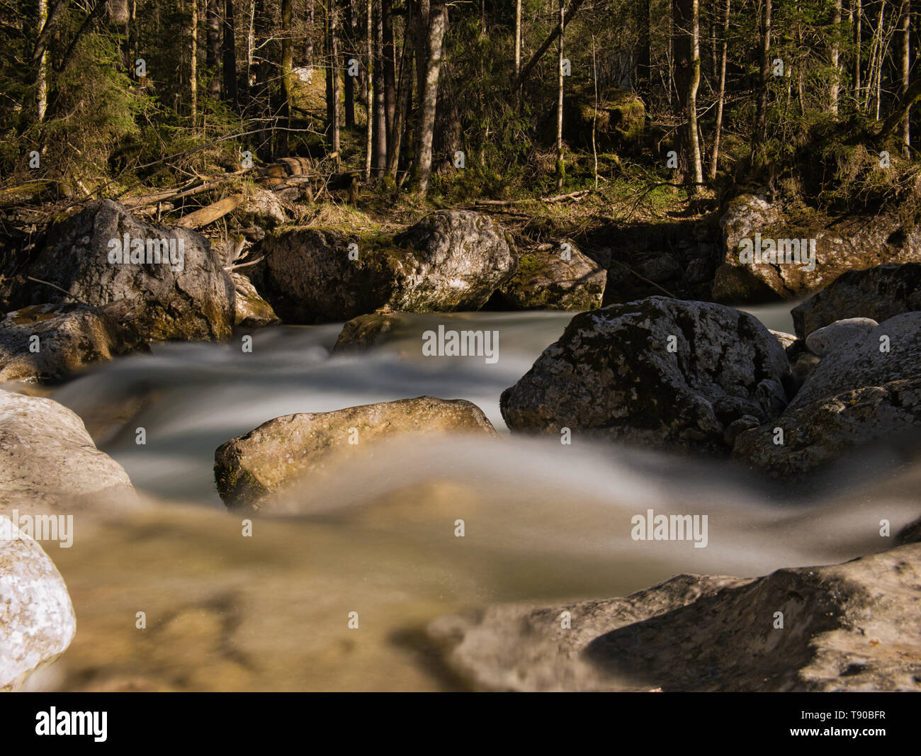 Long-term exposure of a mountain stream in Bavaria with large rocks in the water Stock Photo