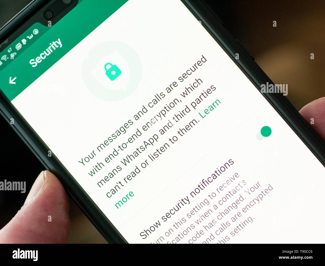 WhatsApp Messenger on a Smartphone, WhatsApp allows users to encrypt their calls and messages for privacy. It is owned by Facebook and founded in 2009 Stock Photo