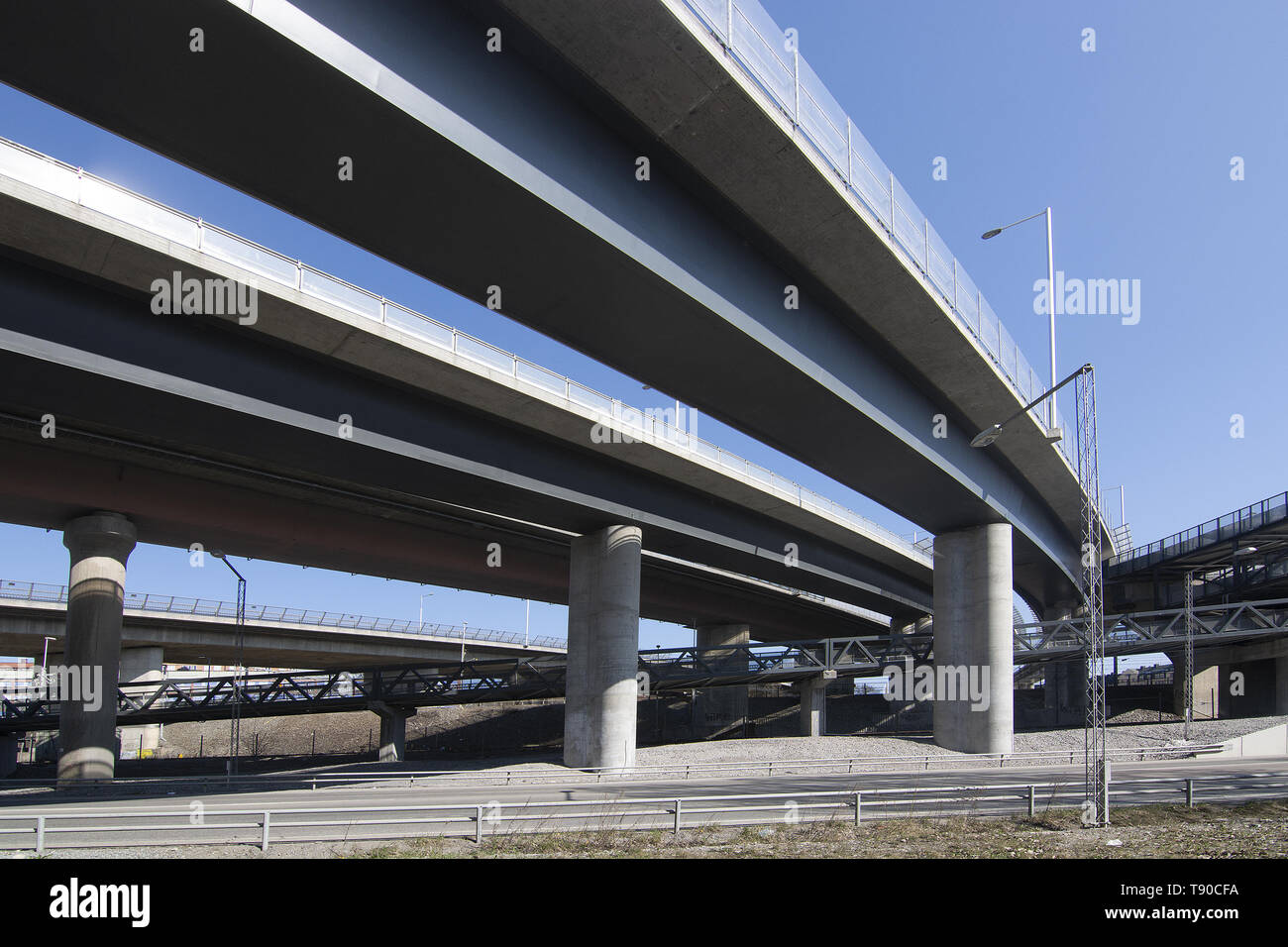 Bridge overpass with light, shadows and perspective under a trafficked lanes in central Stockholm, Sweden. Stock Photo