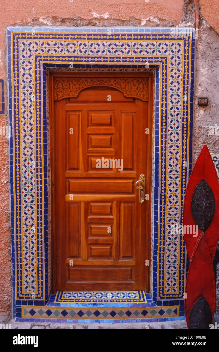 Typical colorful Moroccan wooden front door with rich mosaic decorations as seen in the souks of
