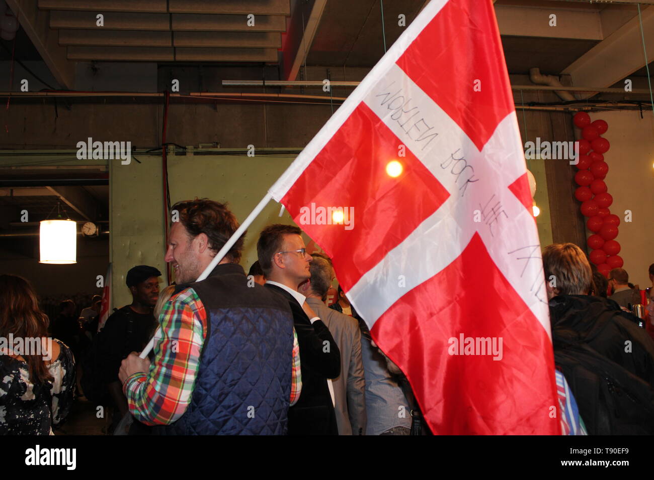 A man holding Danish flag during Danish Parliamentary Election night 2011 Stock Photo
