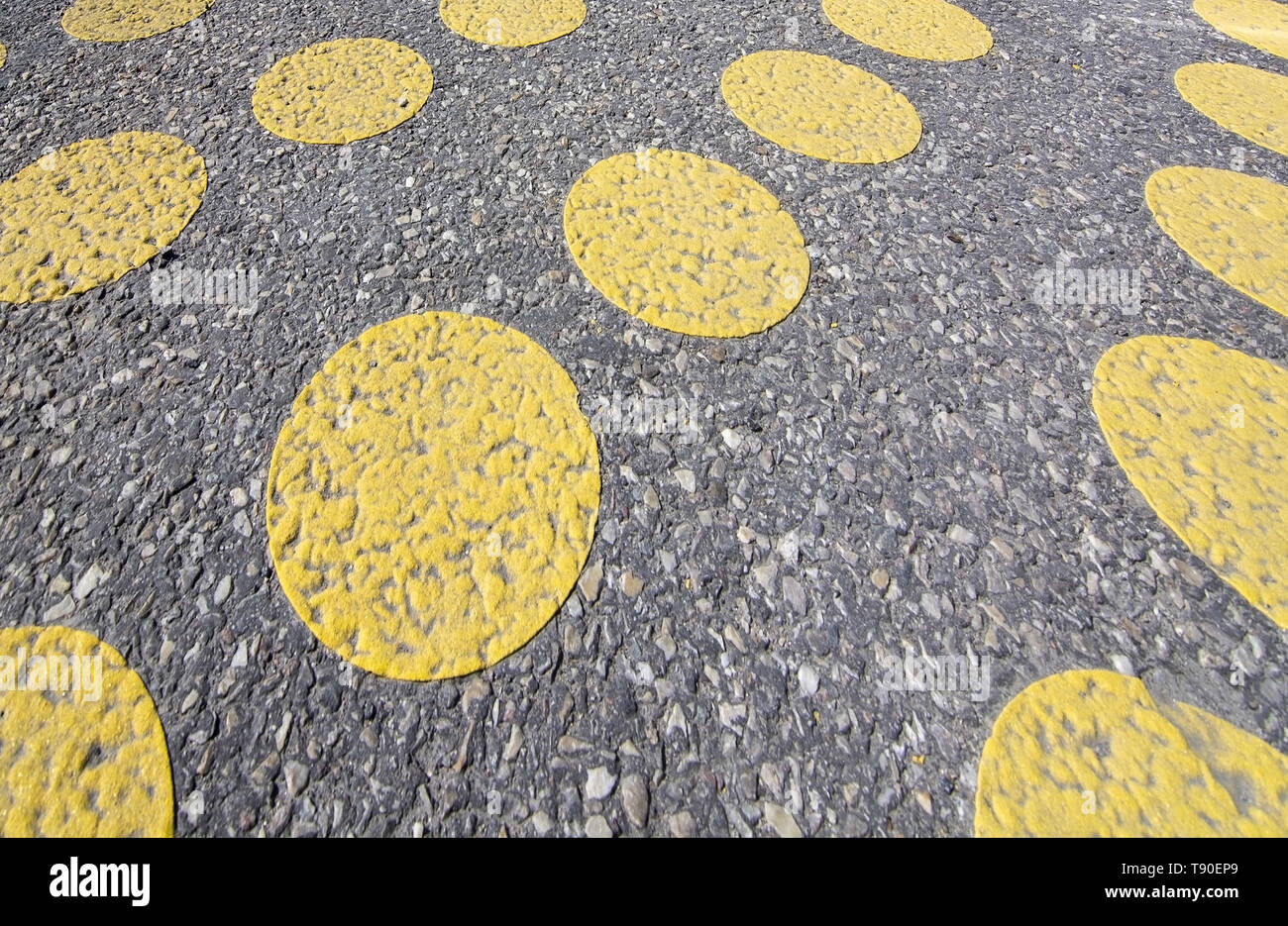 Yellow dots on wide pedestrian bridge next to car route in Stockholm, Sweden. Stock Photo