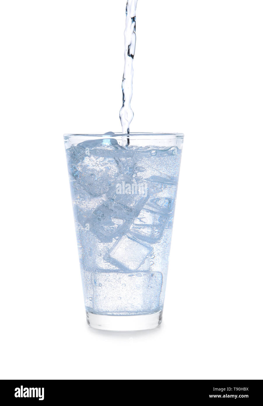 Pouring of water in glass with ice on white background Stock Photo - Alamy