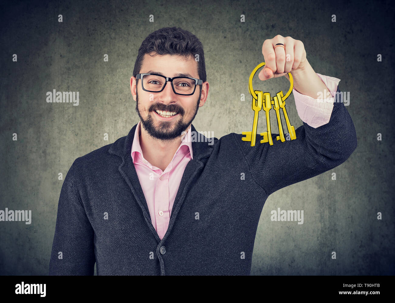 Handsome happy man holding old keys Stock Photo - Alamy