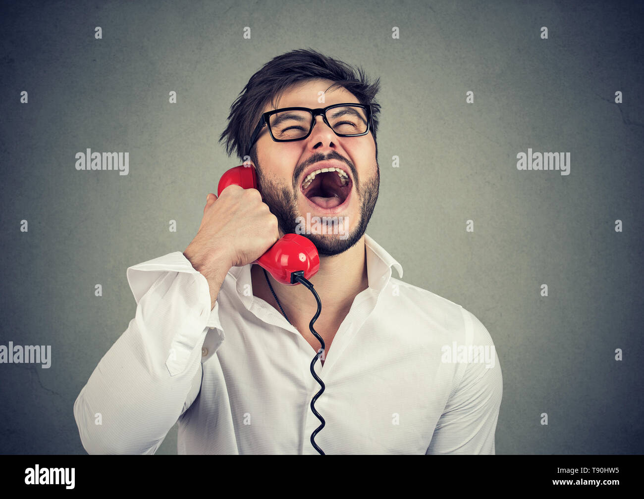 Funny guy on the red telephone Stock Photo