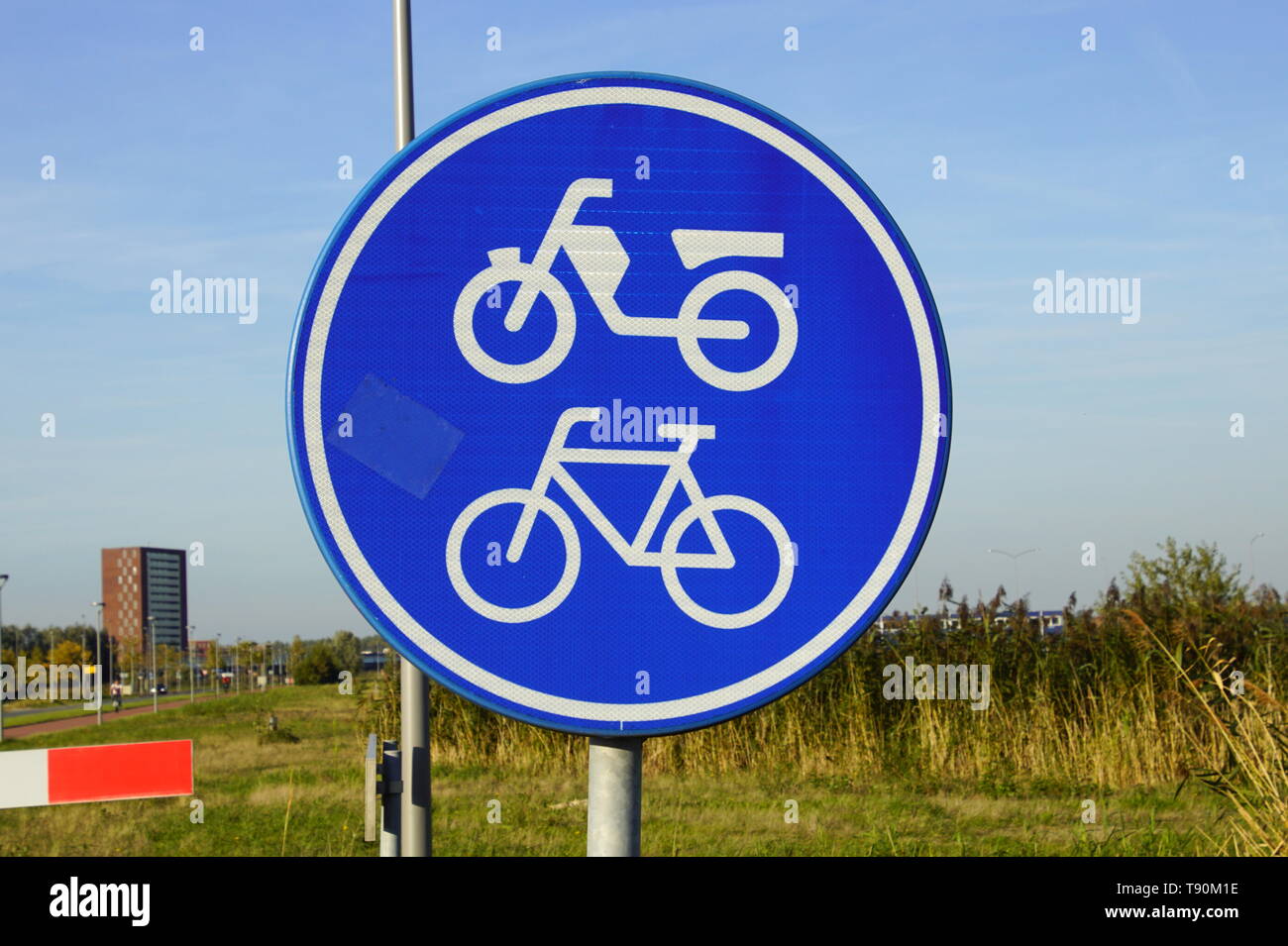 Dutch traffic road sign for moped and bicycle path or cycle lane (Dutch: brommer- en fietspad). Stock Photo