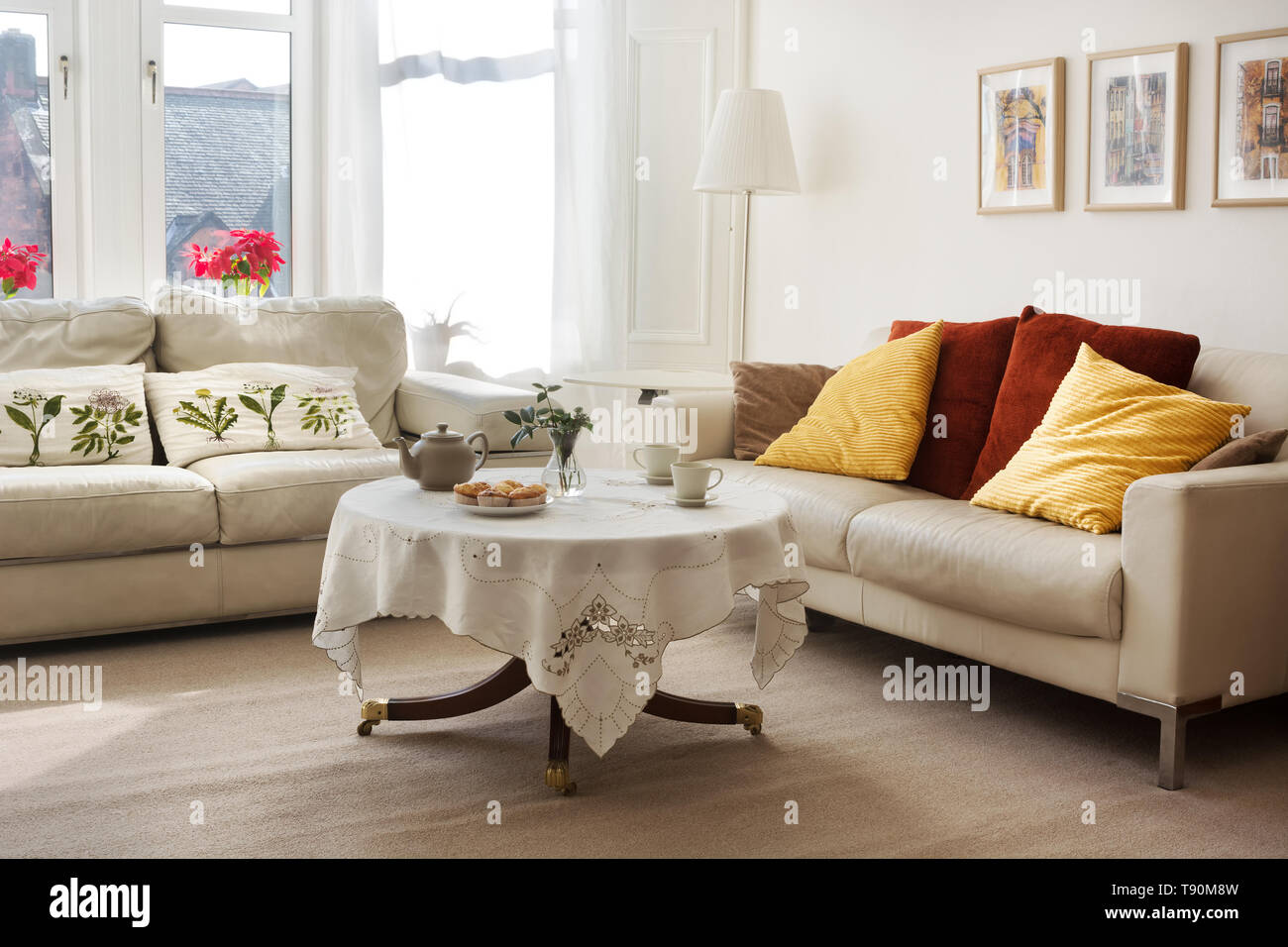 Sunlit Classic Style Living Room With Two Leather Sofas And Tea