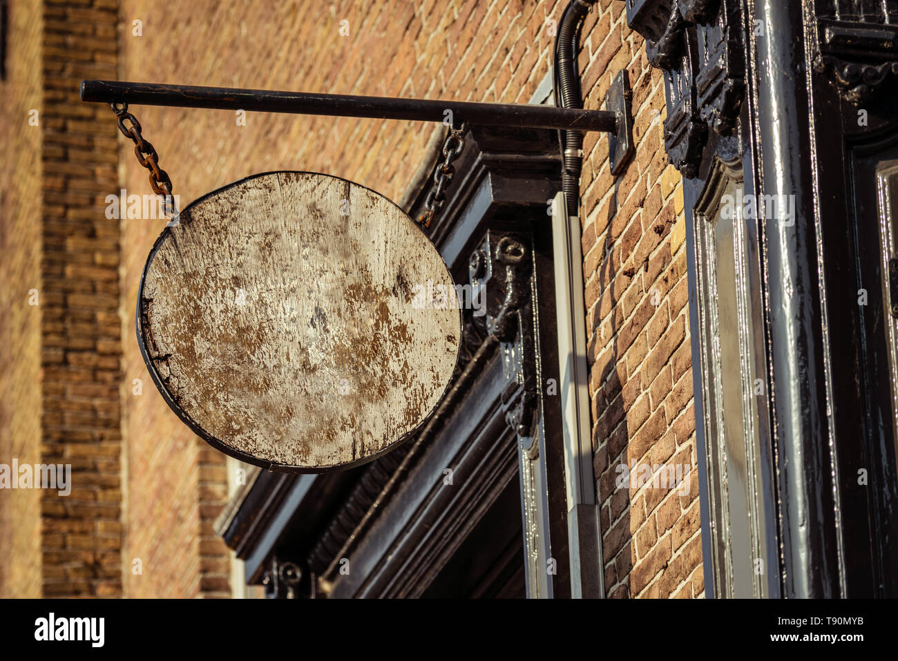 Ornate wooden sign mock-up for store name on building facade exterior Stock Photo