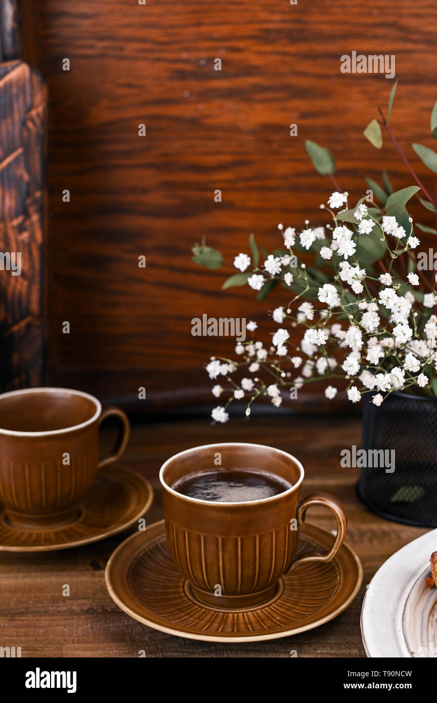 Cups for tea in vintage style with elements of decor. Wooden background
