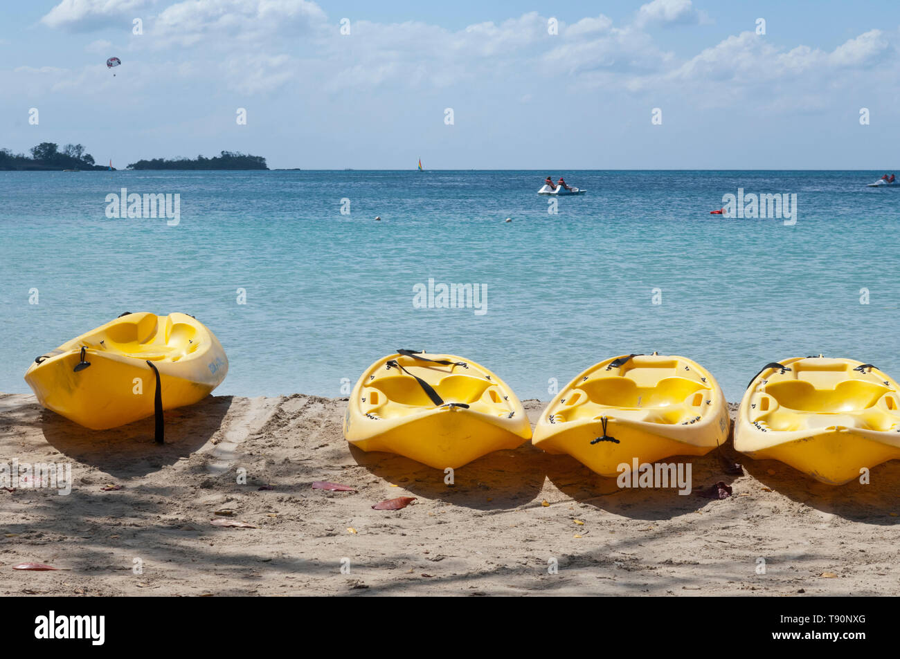 Yellow kayaks on the beach with turquoise Caribbean sea Stock Photo