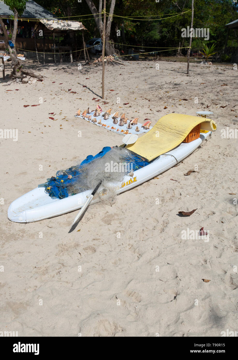 White paddle board used by the Jamaican fisherman to fish with a net