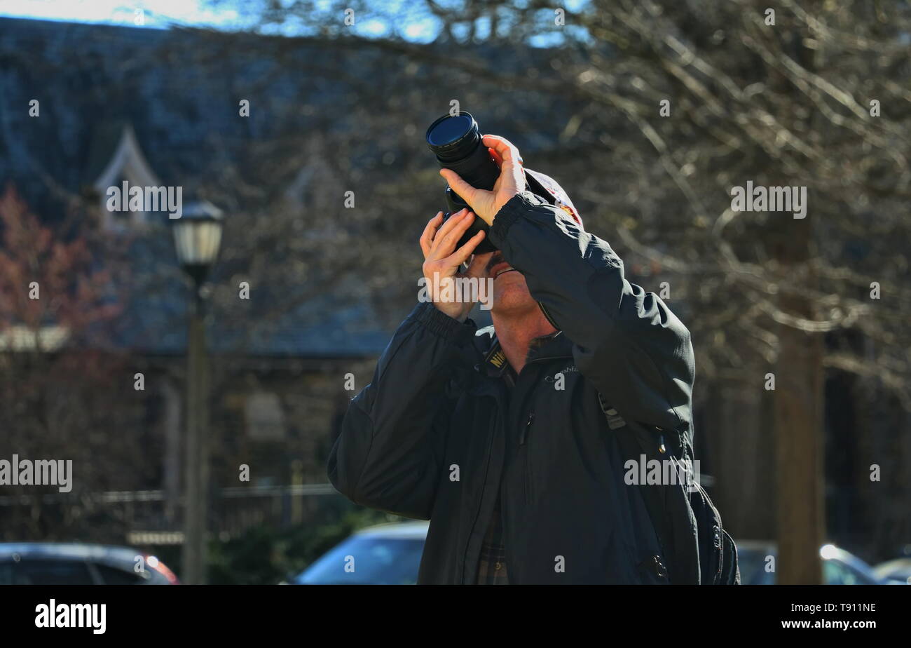 Caucasian man taking photos in front of the Washington National Cathedral Stock Photo