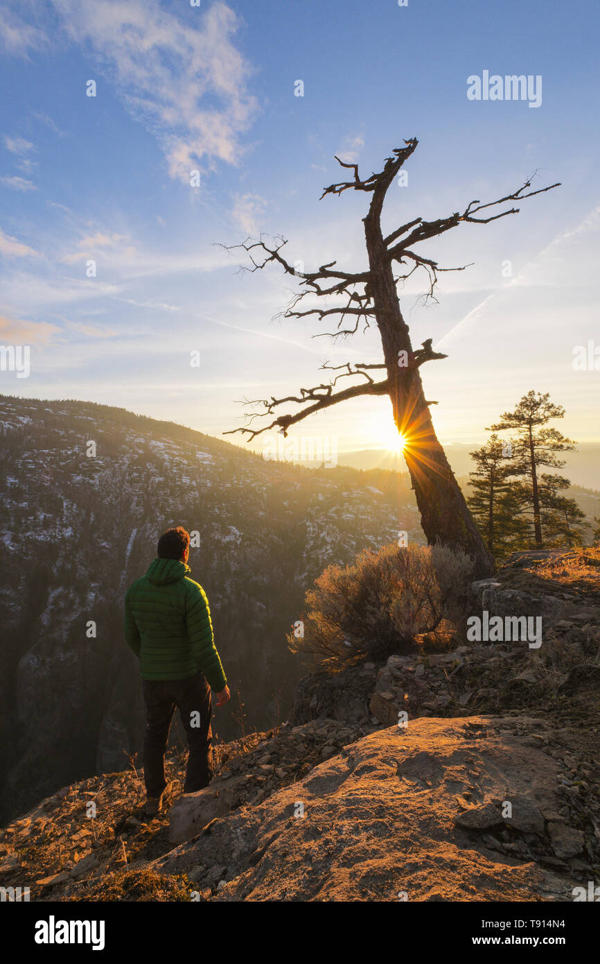 Hiker over looking the Ellis Creek Canyon at sunset in Penticton, British Columbia, Canada Stock Photo