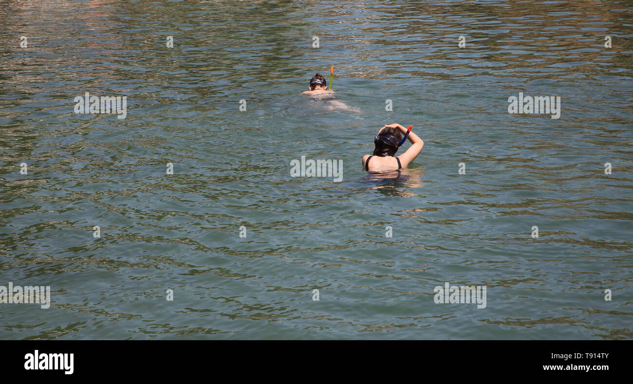 Vouliagmeni Athens Greece Tourists Swimming in Lake Vouliagmeni a Natural Spa - Was Once a Cavern But the Cave Roof Fell in Caused by Erosion from the Stock Photo