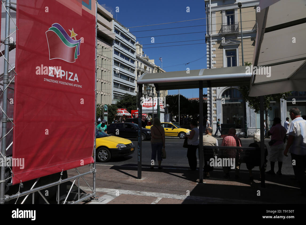 Athens Greece People Waiting at Bus Stop SYRIZA Party Political Poster Stock Photo