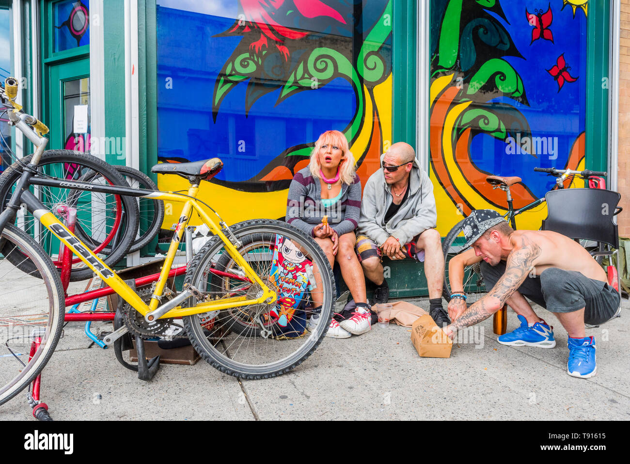 Colourful window and street people, Hastings St, DTES, Vancouver, British Columbia, Canada. Stock Photo
