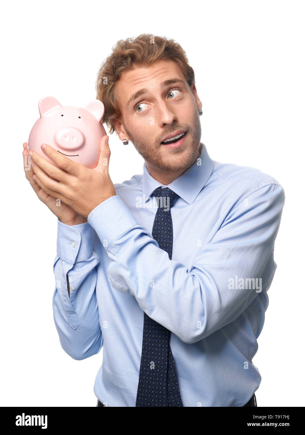 Handsome man with piggy bank on white background Stock Photo - Alamy