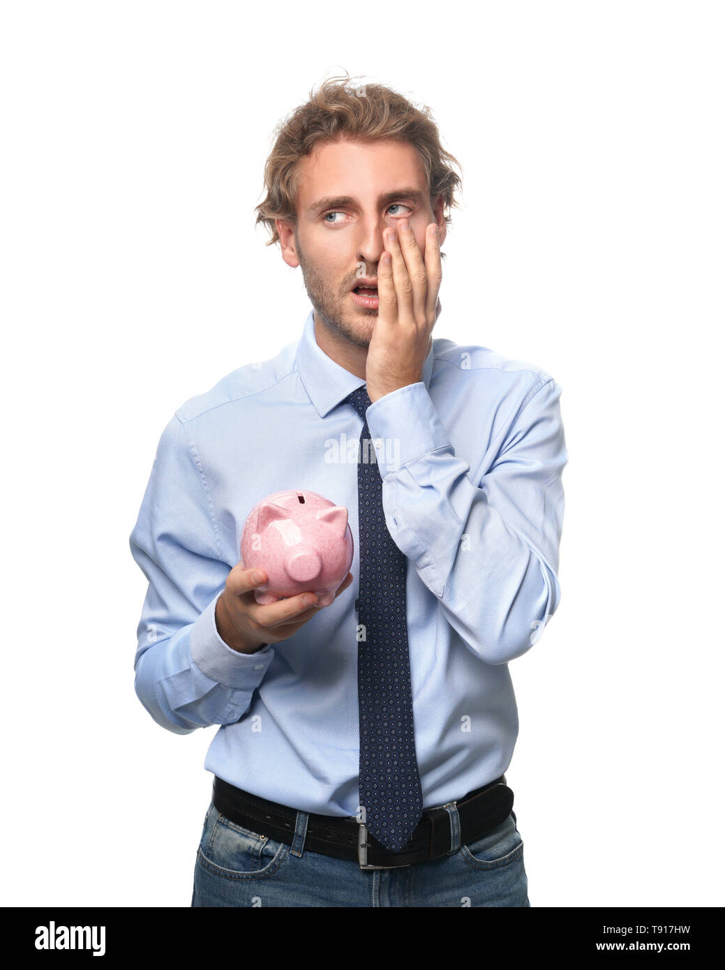 Upset man with piggy bank on white background Stock Photo - Alamy