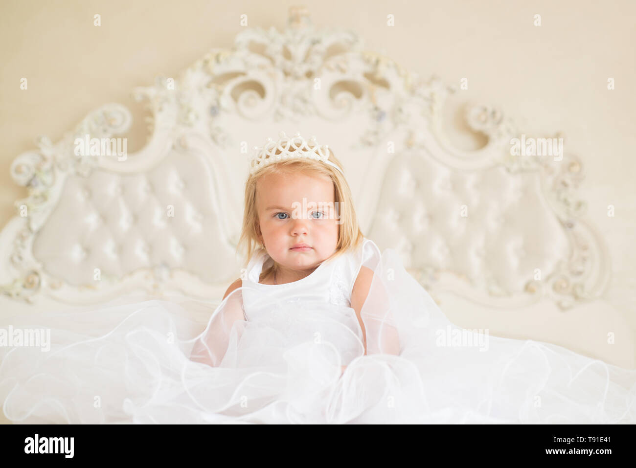 Fairytale princess. Small blond child sit on bed. Little girl wear tiara crown and hairstyle. Hair accessory. Little child with long blond hair Stock Photo - Alamy Fairytale princess. Small blond child sit on bed. Little girl wear tiara crown and hairstyle. Hair accessory. Little child with long blond hair Stock Photo - Alamy