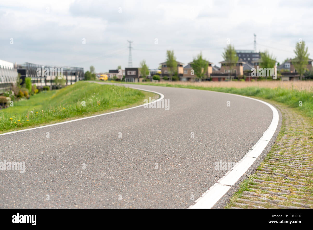 Empty curved road on a dam in the dutch countryside, Capelle Aan Den Ijssel, Netherlands Stock Photo