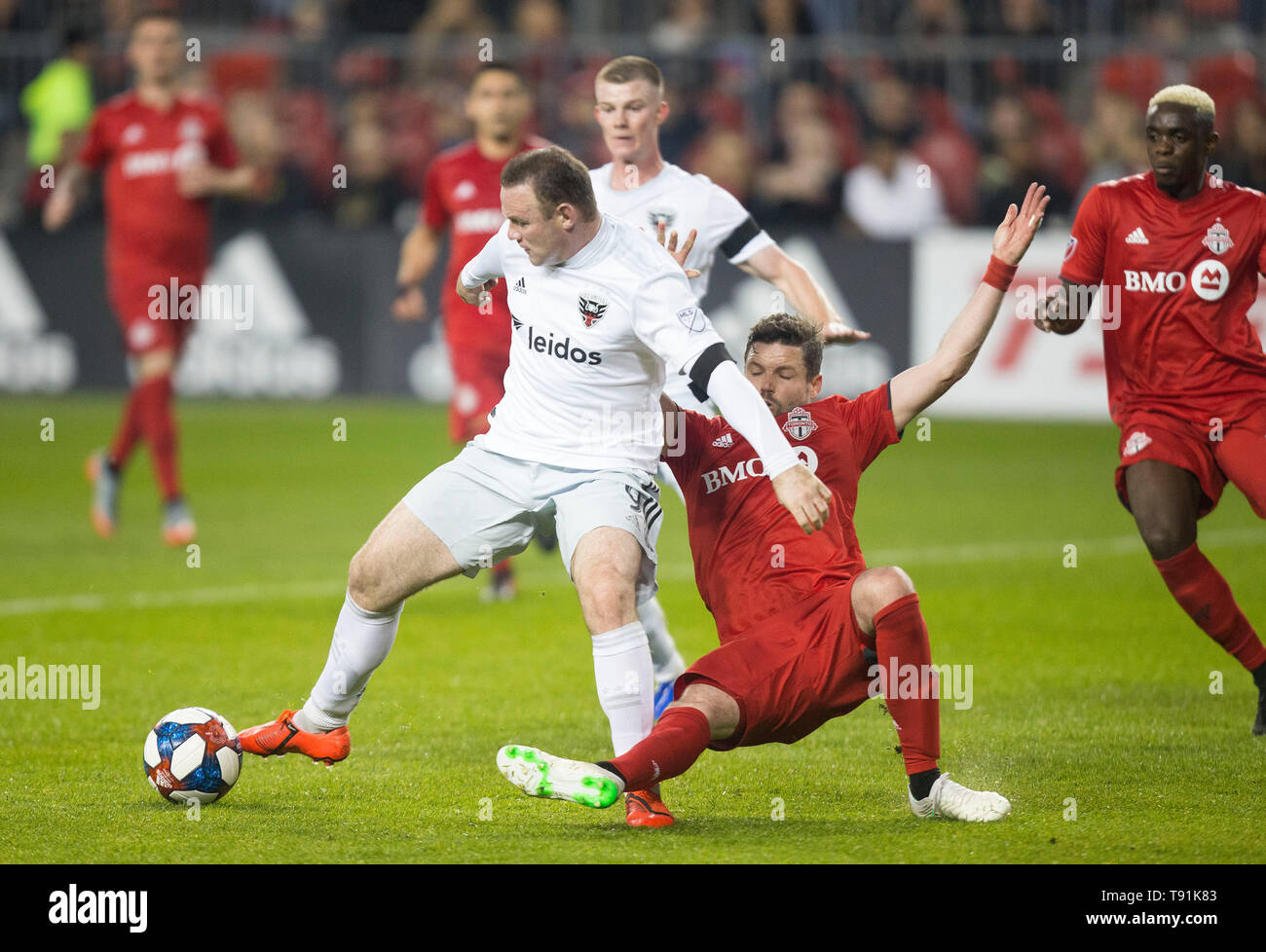 Toronto, Canada. 15th May, 2019. Drew Moor (2nd R) of Toronto FC vies with Wayne Rooney of D.C. United during their 2019 Major League Soccer (MLS) match at BMO Field in Toronto, Canada, May 15, 2019. Credit: Zou Zheng/Xinhua/Alamy Live News Stock Photo