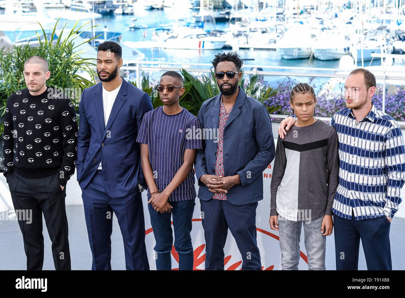 Cannes, France. 16th May 2019. Director Ladj LY and cast poses at a photocall for Les Miserables on Thursday 16 May 2019 at the 72nd Festival de Cannes, Palais des Festivals, Cannes. Pictured: Director Ladj LY, Damien Bonnard, Alexis Manenti, Djebril Zonga, Issa Perica, Al Hassan Ly, Almamy Kanoute, Steve Tientcheu, Nizar Ben Fatma, Lucas Omiri, Oumar Soumare, Magid, Nabil Akrouti, Bachir Ghouinem, Zorro Lopez, Diego Lopez, Rocco Lopez, Jaihson Lopez, Et Luciano Lopez, Giordano Gederlini, Toufik Ayadi, Christophe Barral . Picture by Credit: Julie Edwards/Alamy Live News Stock Photo