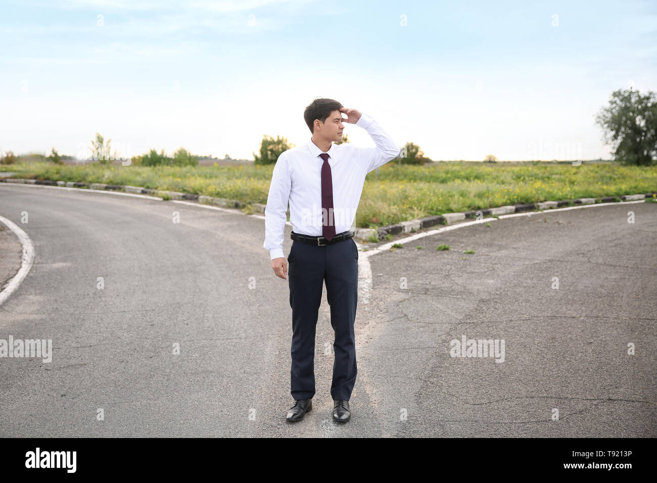 Businessman standing at crossroads. Concept of choice Stock Photo