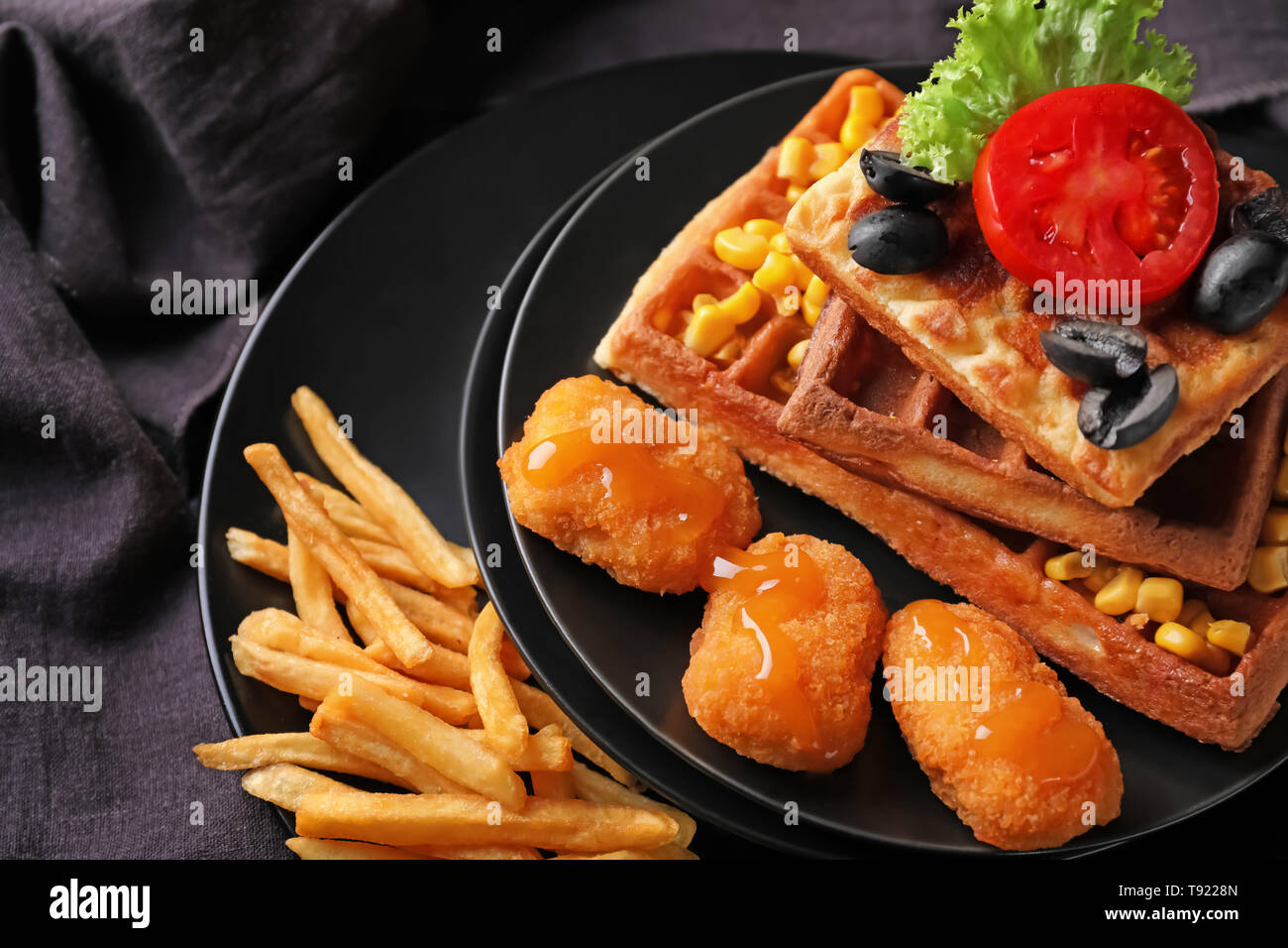Delicious Waffles With Chicken Nuggets And French Fries On Plates Stock Photo Alamy