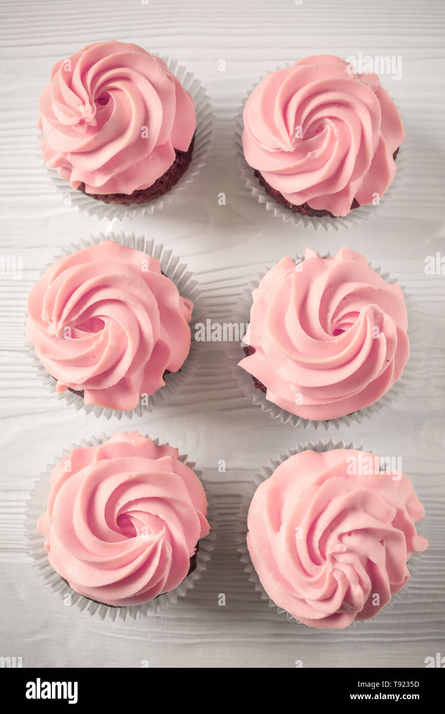 Sweet cupcakes on light background Stock Photo