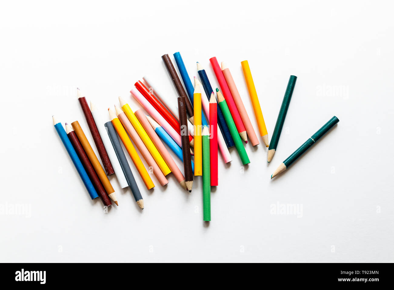 Multicoloured pencils scattered on a white background Stock Photo