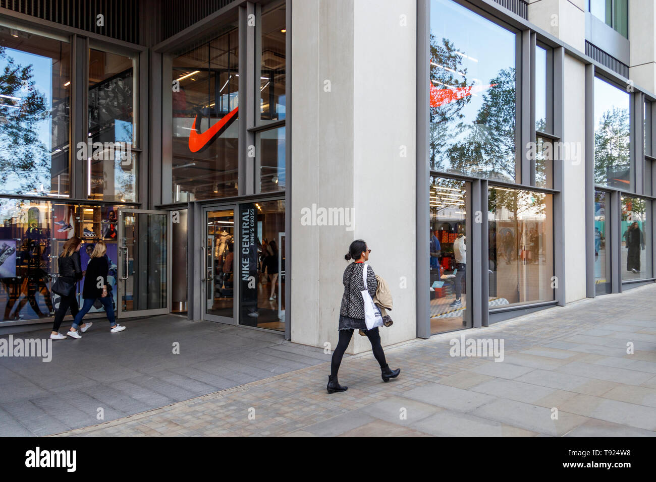 A woman walks past the Nike Central store on King's Boulevard, King's Cross,  London, UK Stock Photo - Alamy