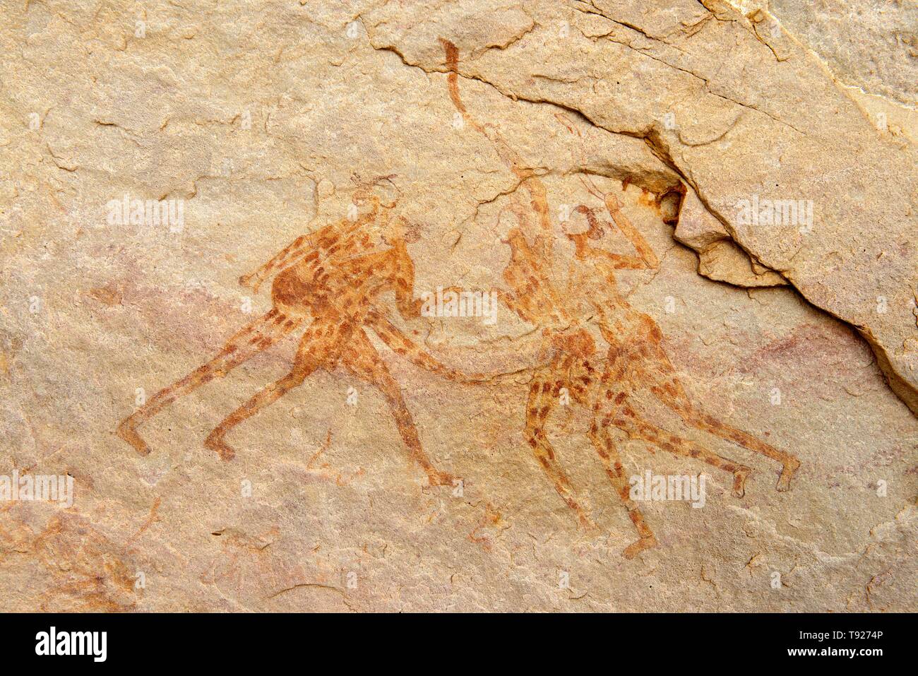 Neolithic rock painting, group of fighting or dancing people, Iheren-Tahilahi style, Tadjelahine Plateau, Tassili n'Ajjer National Park, Unesco World Stock Photo