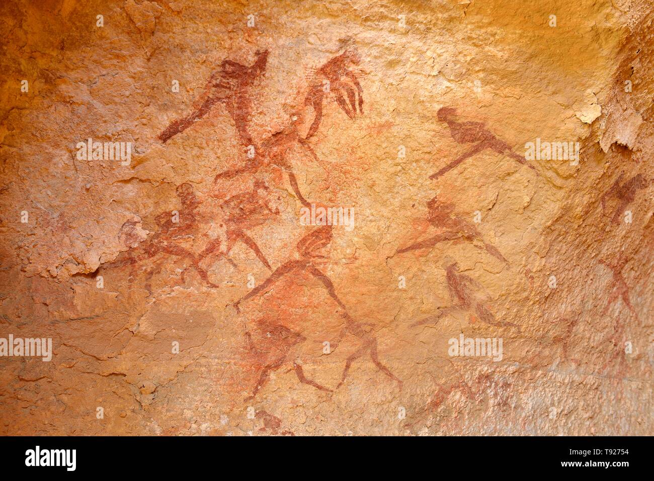 Neolithic rock painting, group of hunting people, Tin Abenhar, Abaniora style, Tadjelahine Plateau, Tassili n'Ajjer National Park, Unesco World Stock Photo