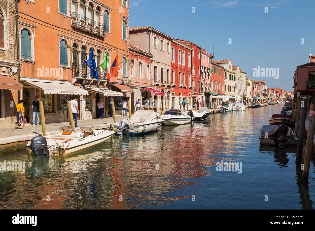 Moored boats on canal with colourful residential buildings, Murano Island, Venice Lagoon, Veneto, Italy Stock Photo