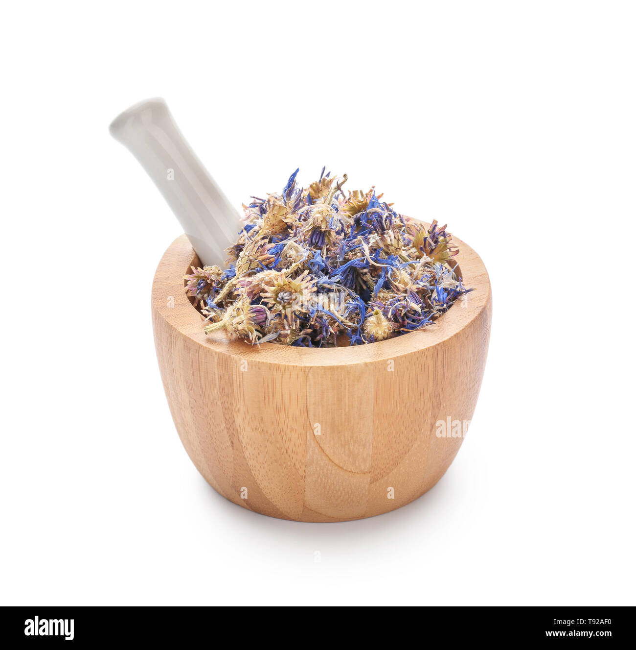 Mortar and pestle with dried flowers on white background Stock Photo