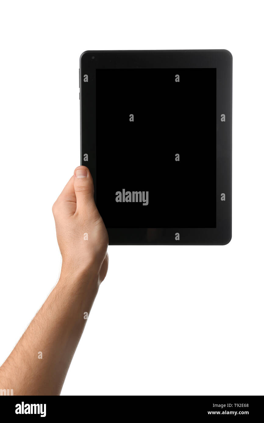Young man holding tablet PC on white background Stock Photo - Alamy