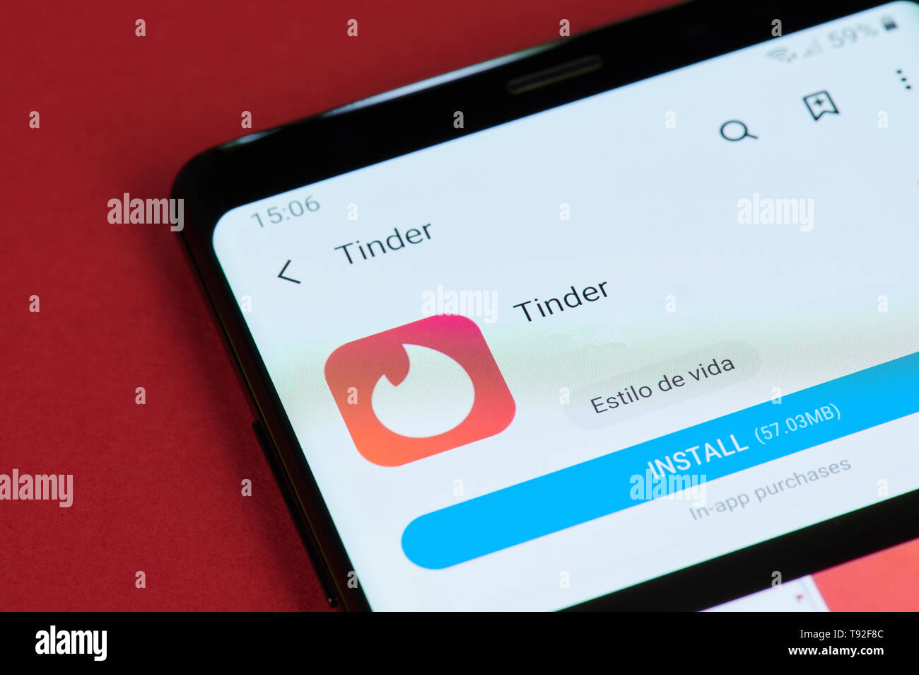 New york, USA - May 15, 2019: Installing tinder app on smartphone screen close up Stock Photo