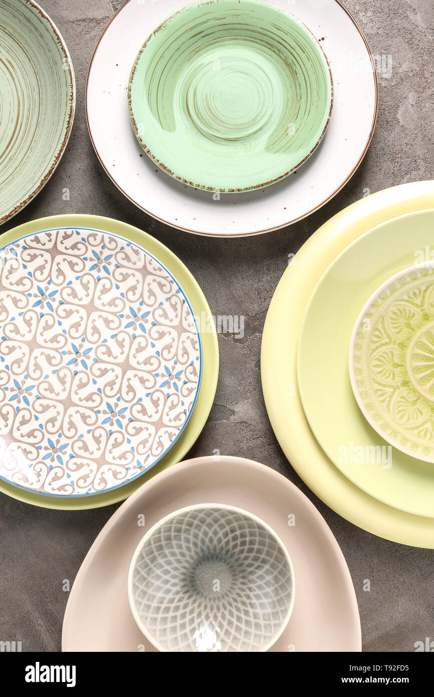 Set of clean color plates on table Stock Photo - Alamy