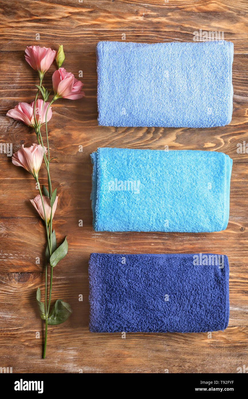 Clean soft towels on wooden background, top view Stock Photo