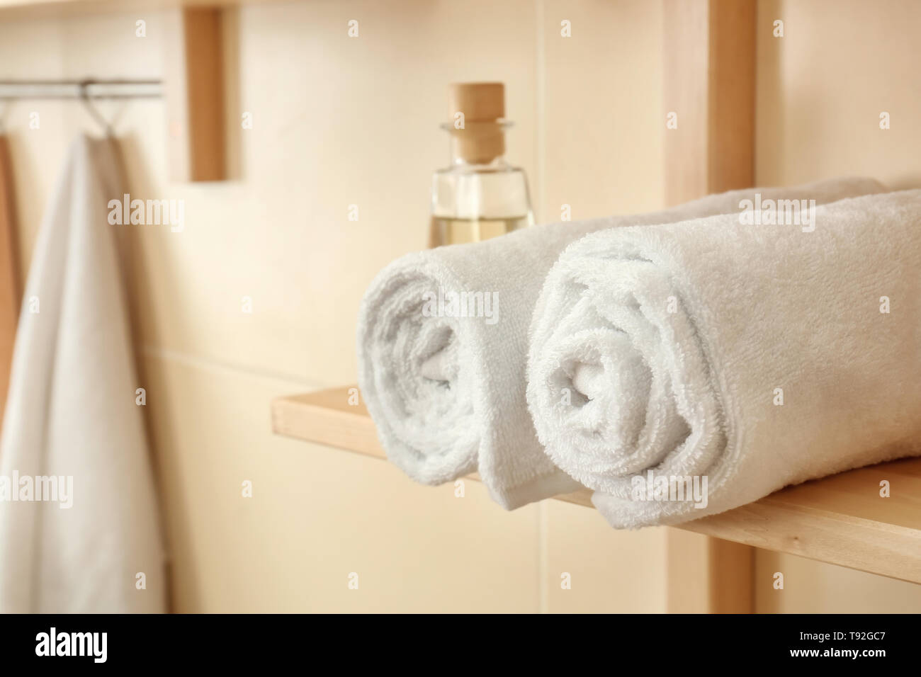 Rolled clean soft towels on shelf in bathroom Stock Photo Alamy