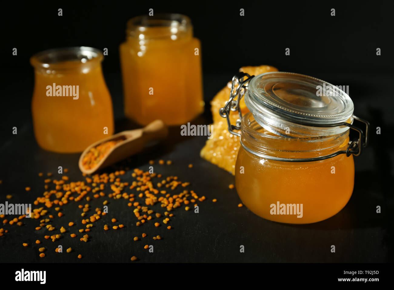 Opened jar with honey on dark table Stock Photo Alamy