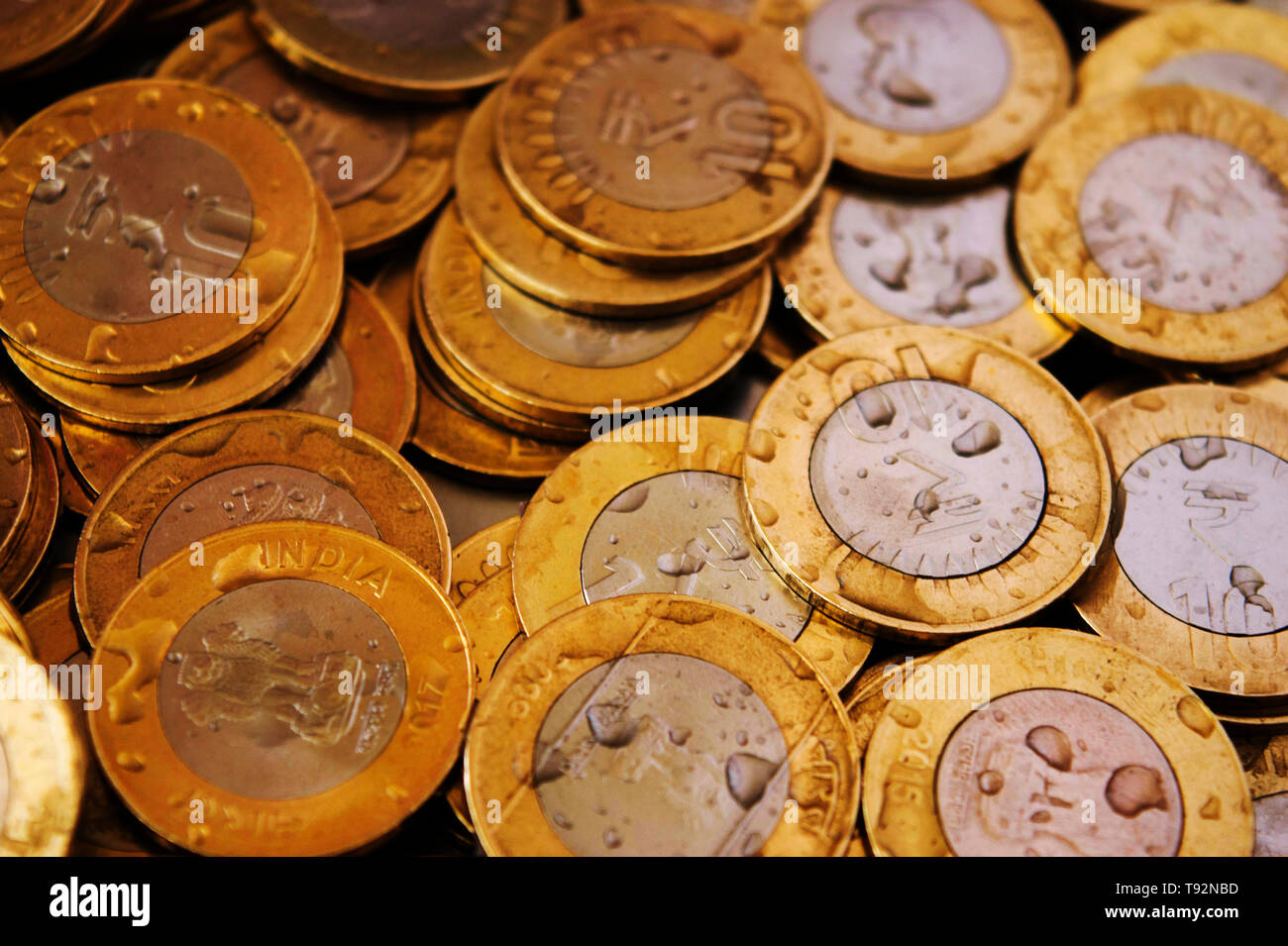 10 rupee coins with water drops. Stock Photo