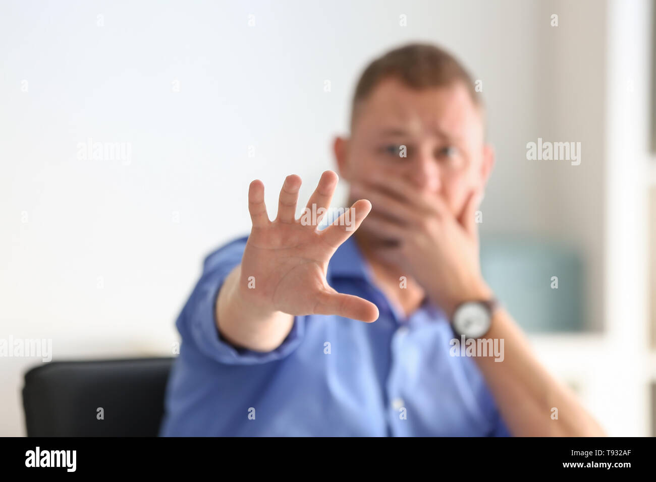 Man having panic attack at workplace in office Stock Photo